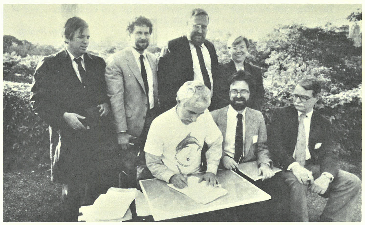 NYC Parks Commissioner Henry Stern signing over management of Dubos Point Sanctuary to NYC Bird Alliance. Also seated (left to right): past Board Member Drew Lehman and past Board President and Secretary Geoffrey Cobb Ryan. Standing (left to right): Bernard Blum of Friends of Rockaway, Marc Matsil of NYC Parks, past Board President and Vice President Albert F. Appleton, and NYC Parks Deputy Commissioner Diana Chapin. Photo: Calvin Wilson/NYC Parks