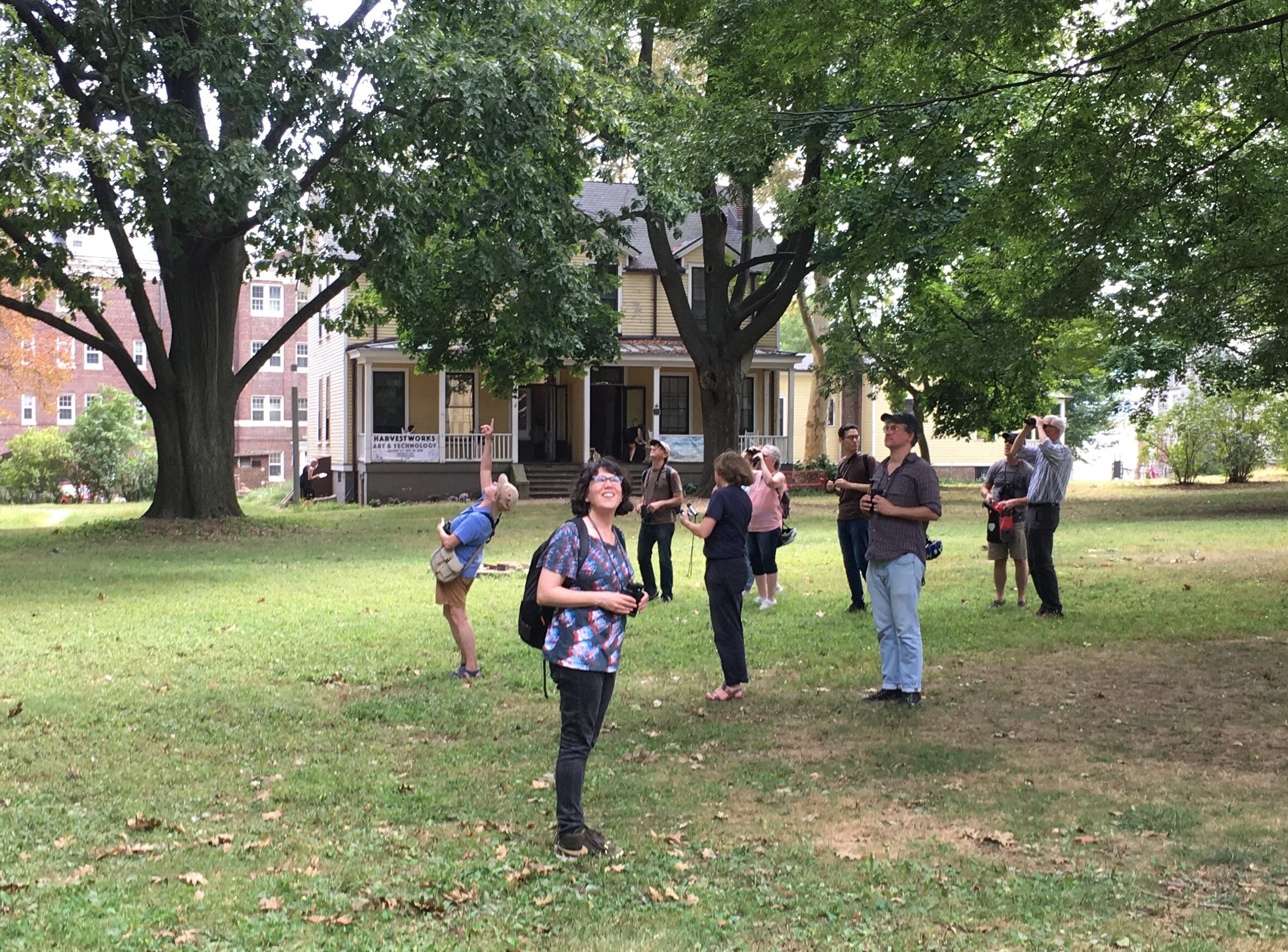 NYC Bird Alliance Guide Annie Barry points out a songbird in the trees. Photo: NYC Bird Alliance